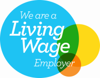 We are a living wage employer! The logo is a blue circle with white font, there are smaller yellow and orange circles where they overlap the blue they have turned green.