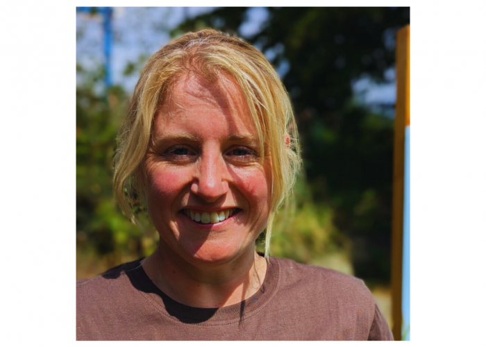 Gillian, a blonde woman smiling in front of trees